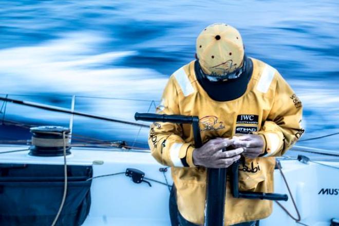 Daryl Wislang takes a look at the toll days of wet reaching has taken on his hands as the wind lets up at dusk in the Pacific Ocean - Volvo Ocean Race 2014-15 © Matt Knighton/Abu Dhabi Ocean Racing